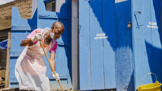 A hygienist cleans newly constructed latrines at a health centre in the Democratic Republic of the Congo