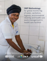 Health care worker washing hands at sink